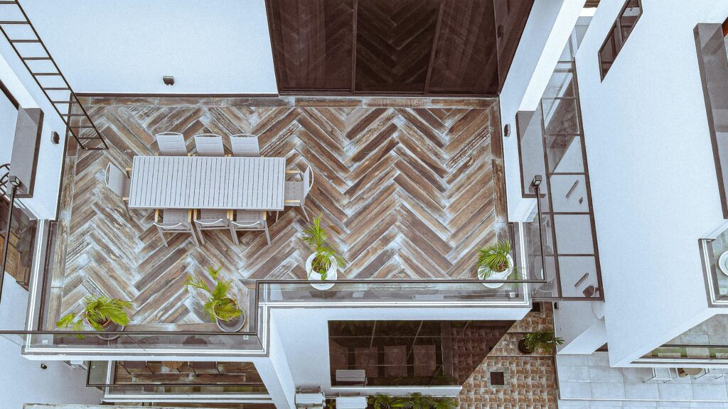 Aerial view of a stylish rooftop terrace with dining area and plants in Dar es Salaam, Tanzania.